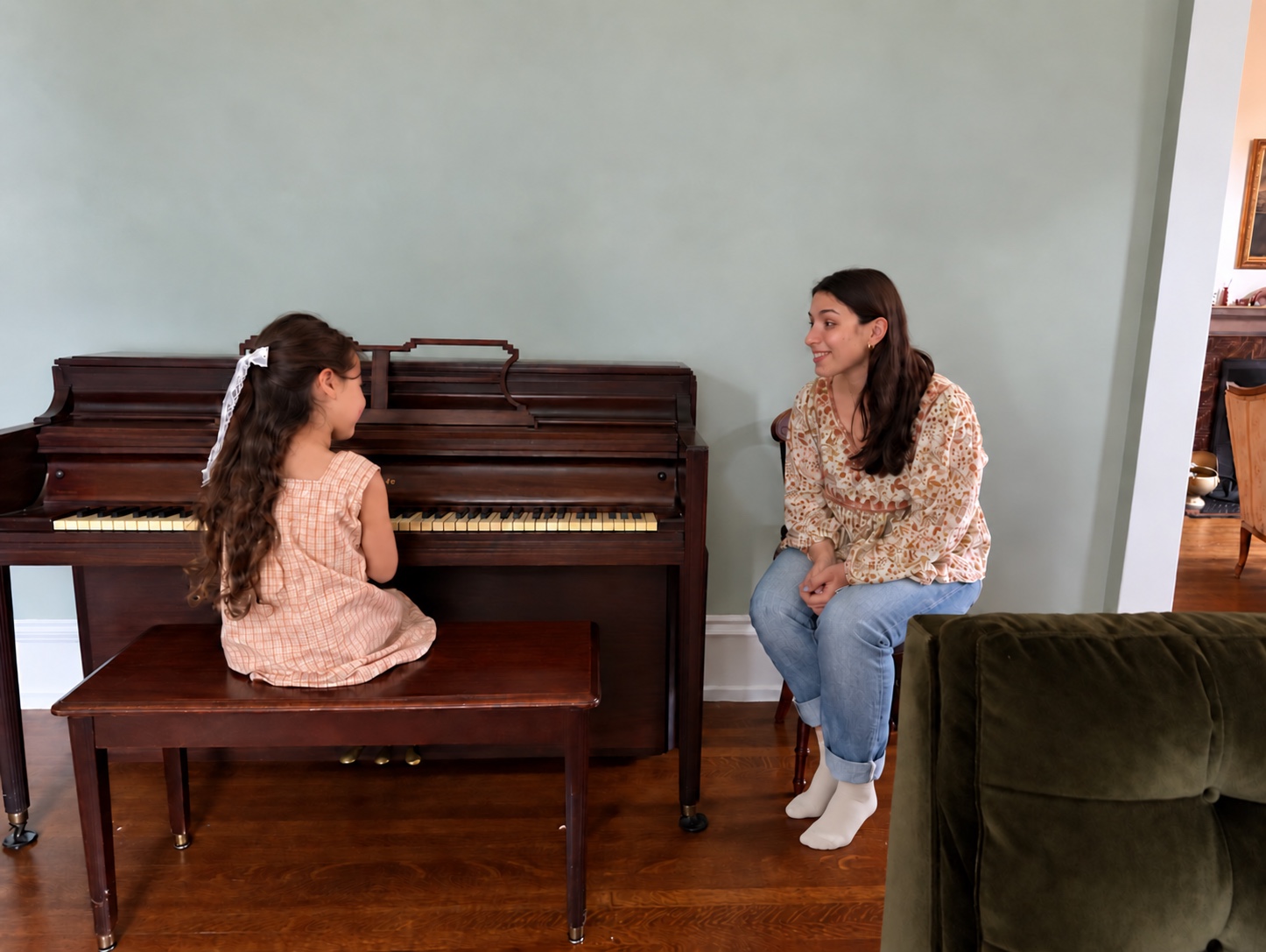 Annabelle guiding a young learner during a piano lesson